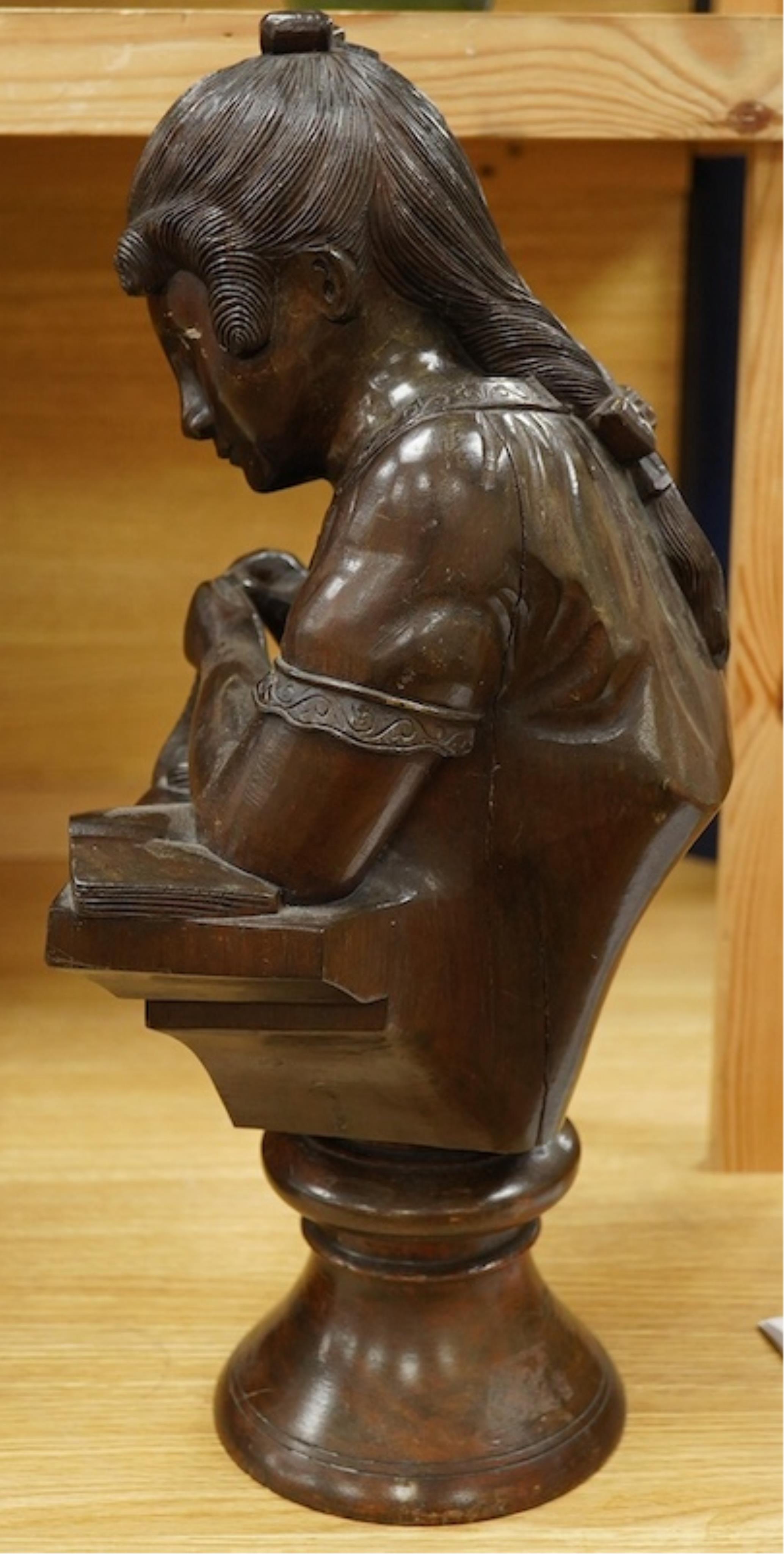 A carved wood bust of a girl sewing, 47cm high. Condition - two old cracks to the back of carving